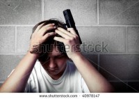 stock-photo-teen-depression-teenager-with-hands-on-head-holding-handgun-40978147