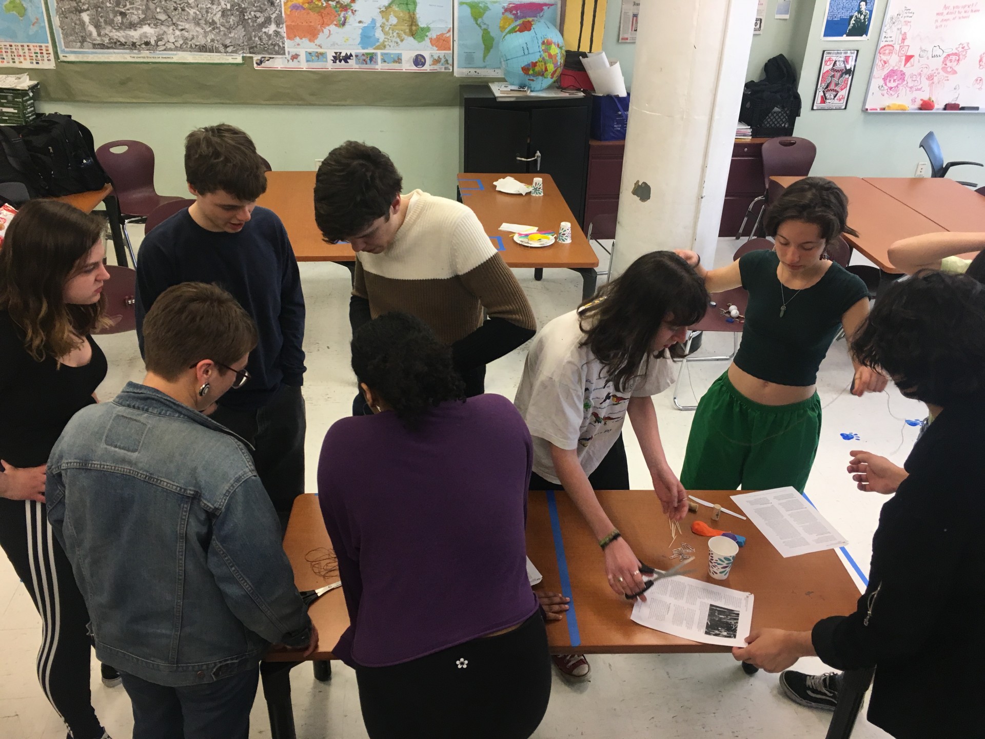 Teams 1 & 2 working on their first prompt: to build a tower taller than the desk using unconventional materials