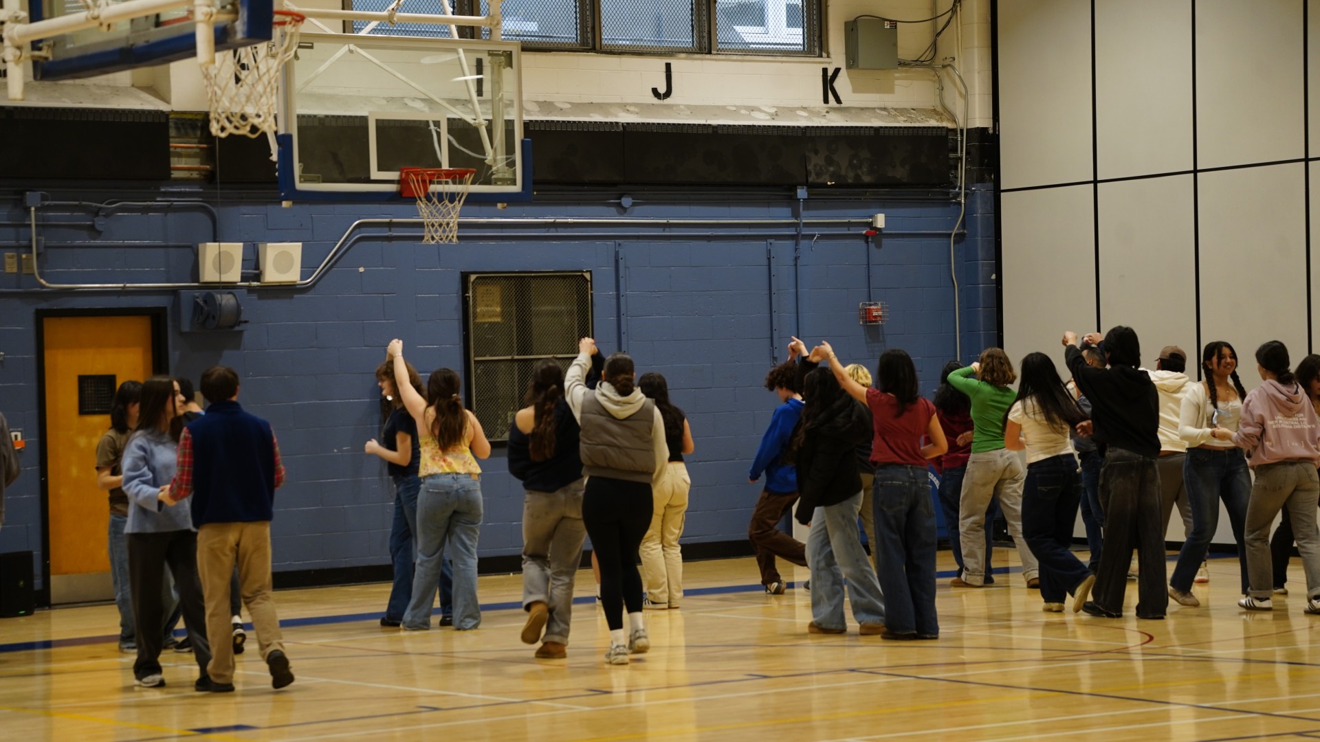 SLA students and Spanish exchange students dancing together during Latin dance lesson.