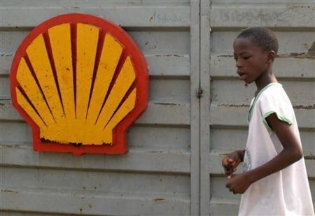 56628-a-nigerian-schoolboy-walks-past-the-logo-of-dutch-oil-giant-